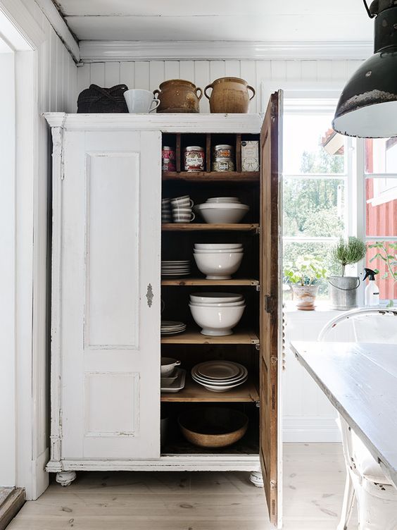 white dishes stacked neatly help keep things visually lovely and decluttered