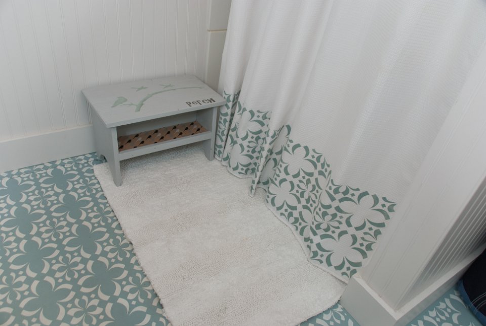 Stencilled flooring and shower curtain are just amazing touches 